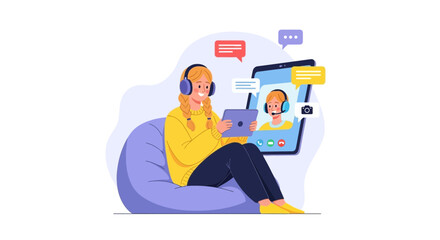 Young woman video calling using tablet while sitting on beanbag chair with headphones and messaging app