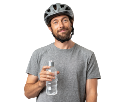 Happy cyclist wearing a helmet, holding a water bottle, ready for a ride.