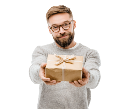 A smiling man with a beard holds out a gift wrapped in brown paper.