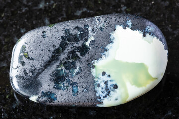 sample of polished khantigirite mineral on black