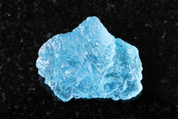 sample of rough aquamarine mineral on black