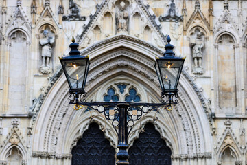 Ornate Victorian Street Lamp in Front of Gothic Cathedral Entrance