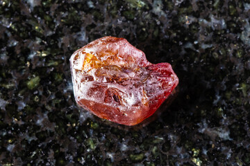 sample of rough hyacinth zircon mineral on black