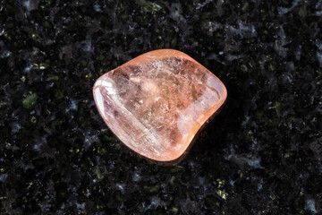 sample of rolled pink tourmaline crystal on black