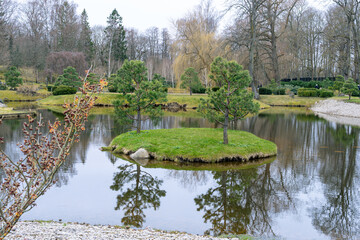 Fototapeta premium Trees on an island at the japanese garden in Tallinn (Estonia)
