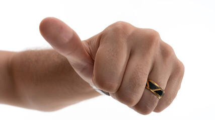 Hand giving thumbs up gesture showing approval or encouragement in close-up with a modern ring on finger