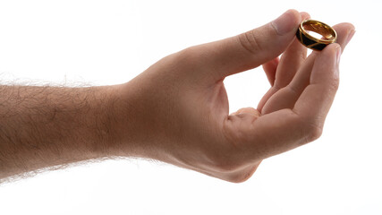 Holding a gold wedding band in hand, symbolizing love and commitment, against a white background