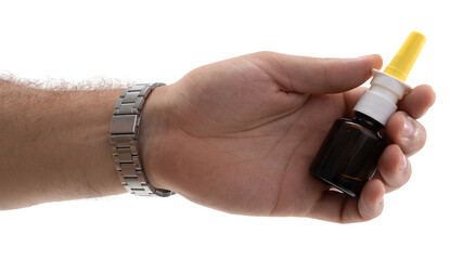 Hand holds nasal spray bottle, demonstrating health care usage for allergy relief during springtime