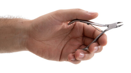 Hand holding professional nail clippers at a nail care salon during a beauty treatment session