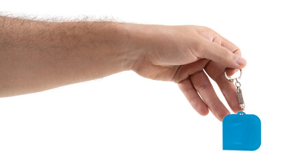 Hand holding a blue keychain with a rounded shape, showcasing a simple design and secure attachment...