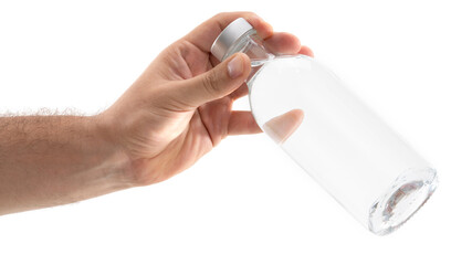 Clear glass bottle held by hand showcasing transparency and water contents in a well-lit environment