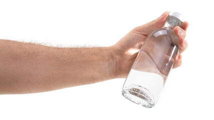 Hand holds a clear glass bottle filled with water in bright lighting, showcasing transparency and...