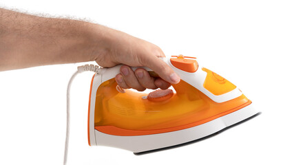 Hand holding an orange steam iron ready for smoothing clothes at home or in a laundry room