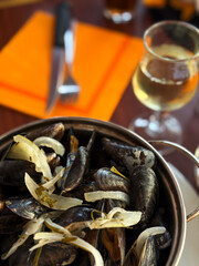 Mussels with onion sauce and white wine in a restaurant