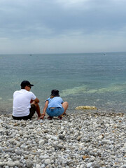 Father and daughter on the seashore communicate and spend time together