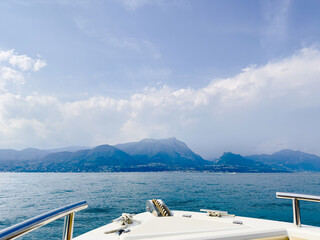 view of the lake and mountains from the deck of a water motor boat. Sea trip
