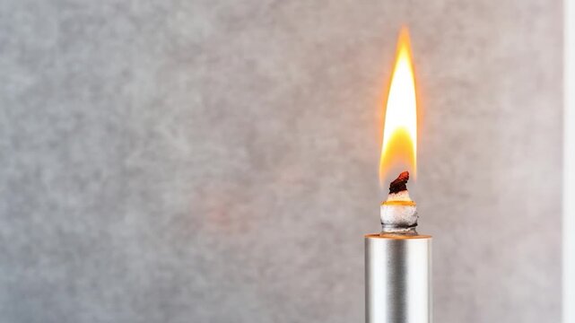 Burning flame on torch against grey background warm light source concept