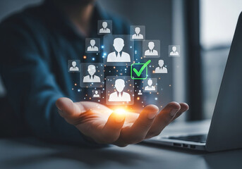 Photo of hand holding virtual profile icons with a green checkmark representing successful candidate selection process for employment