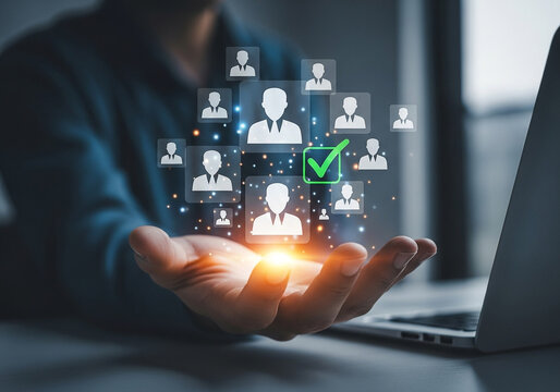 Photo of hand holding virtual profile icons with a green checkmark representing successful candidate selection process for employment