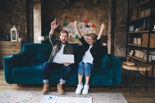 Couple watches animated metrics on laptop screen with excitement, symbolizing digital growth, AI‑powered analytics, interactive charts, UX joy, data‑driven decision, tech synergy.
