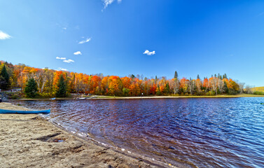 The red color from the maples around the lake reflect on to the water on the lake.