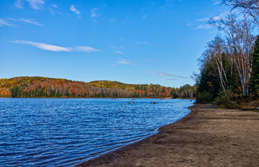 Lazy boating in the fall on the picturesque lake.