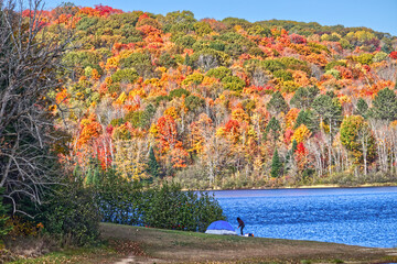 Camping by the lake in the fall under colorful surroundings.
