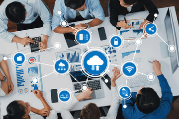 Top view analyst team utilizing BI Fintech to analyze financial data at table in meeting room....