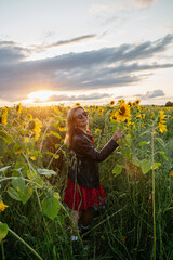 A woman walking through a field of sunflowers