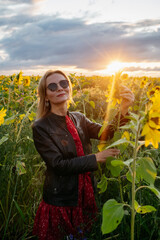 A woman walking through a field of sunflowers
