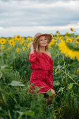 A woman walking through a field of sunflowers