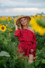A woman walking through a field of sunflowers