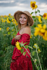 A woman walking through a field of sunflowers