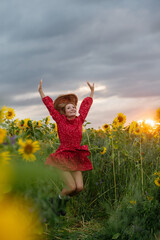 A woman walking through a field of sunflowers