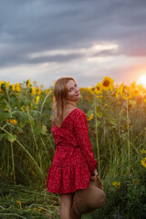 A woman walking through a field of sunflowers