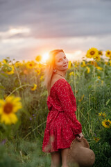 A woman walking through a field of sunflowers