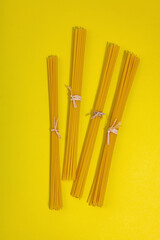 Pasta. Various kinds of uncooked pasta and noodles over wooden background