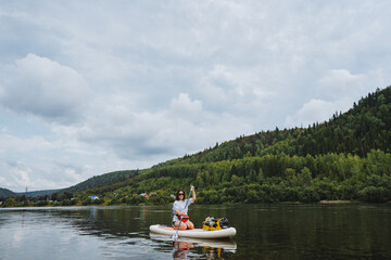 An Adventurous Day on a Serene River Enjoy a Memorable Paddleboarding Experience with Family and...