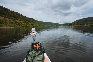Experience a serene kayaking adventure on calm waters surrounded by lush greenery, creating an...