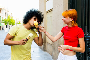 Young couple sharing ice cream cones on a summer day