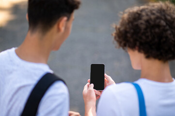 Close up of two teens looking at the phone