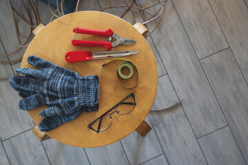 Necessary tools for weaving a rattan basket, top view, gloves, centimeter, knife, and nippers....