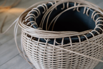 Rattan basket in the process of weaving. A woman's hobby. Natural textures and patterns that create...