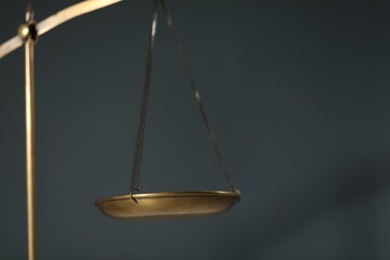 Scales of justice on gray background, closeup. Space for text