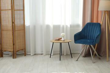 Stylish furniture near window with curtains in living room. Interior design
