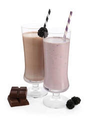 Different tasty milkshakes in glasses and ingredients isolated on white