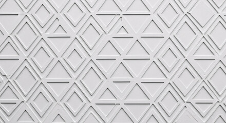 A white surface with a pattern of raised triangles and diamonds creating a geometric design texture on transparent background