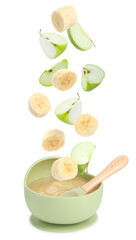 Baby food. Apple and banana slices falling into bowl of puree on white background