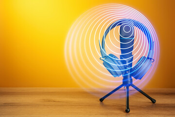 Headphones, microphone and sound waves against orange background
