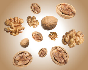 Walnuts swirling in air against pale brown background